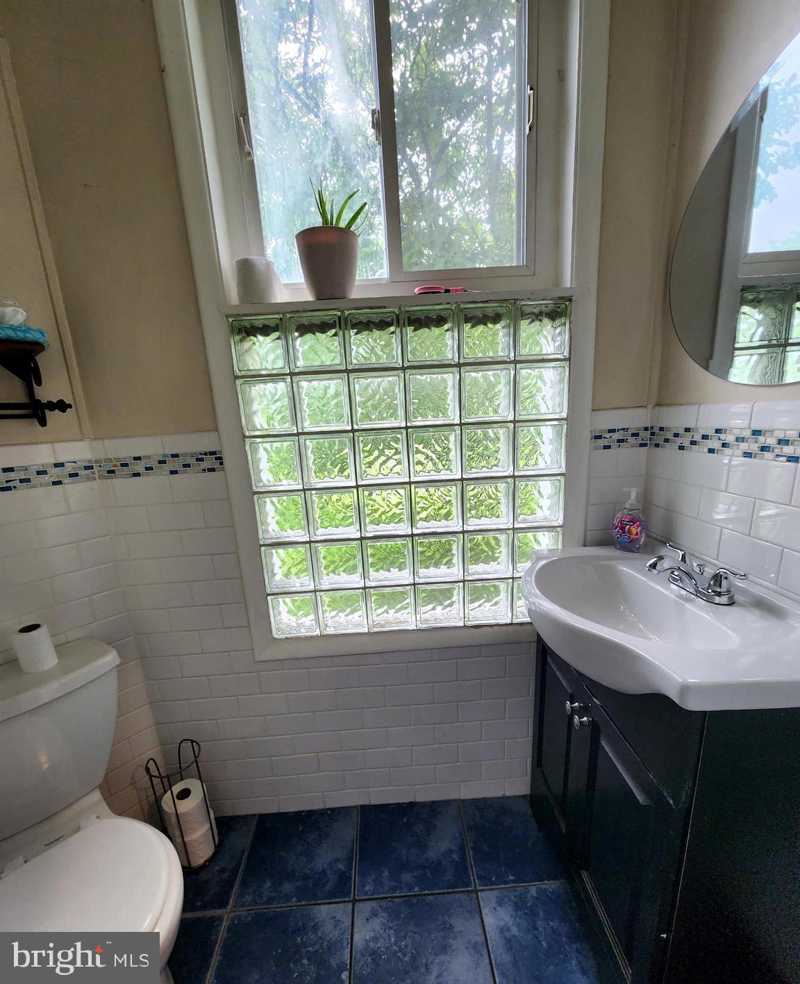 306 Middletown Road Media, PA 19063 - Photo 11 of 22 a bathroom with a sink toilet and a window