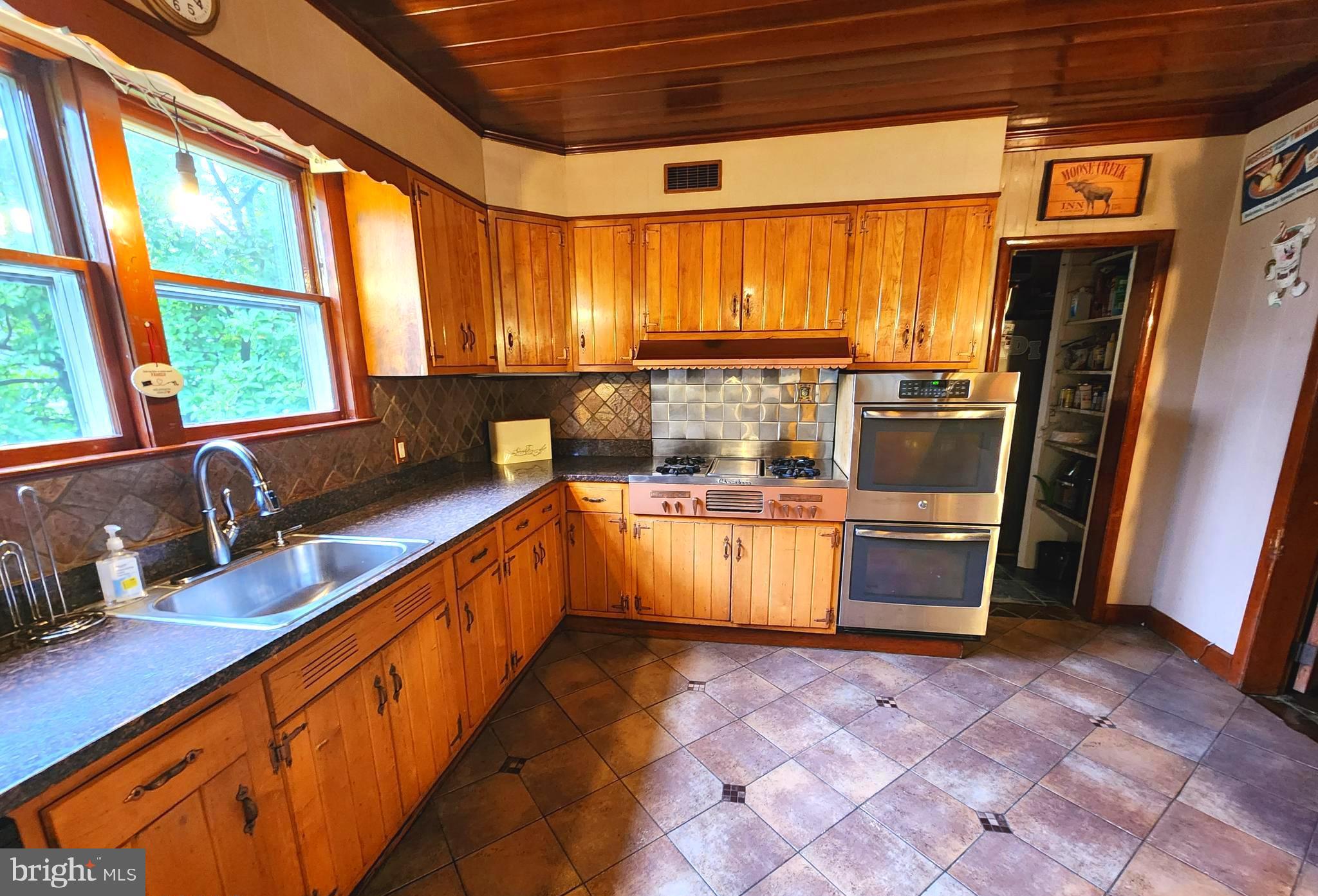 306 Middletown Road Media, PA 19063 - Photo 12 of 22 a large kitchen with stainless steel appliances a large counter top a stove a sink and a refrigerator