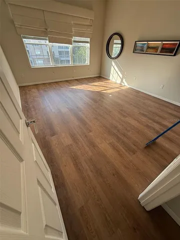 a view of empty room with window and fireplace