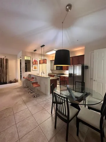 a dinning area with furniture and chandelier