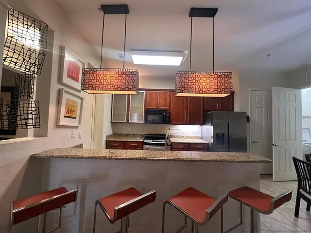a kitchen with a table chairs and a wooden floor