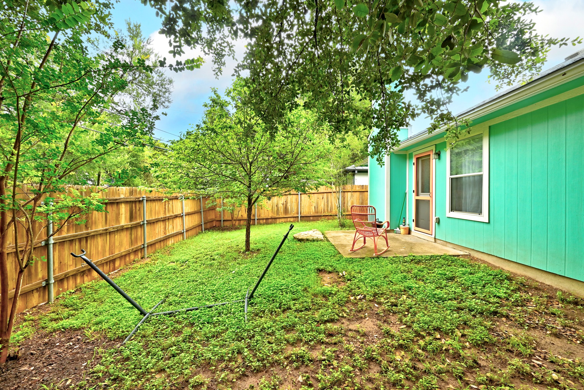 1103 Emmitt Run Austin, TX 78721 - Photo 23 of 25 A private, fenced backyard offers a quiet patio space for relaxation and enjoyment.