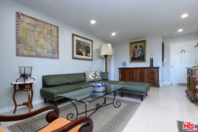 a living room with furniture gym equipment and a flat screen tv