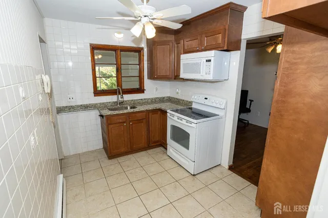 a kitchen with a stove a sink and a refrigerator