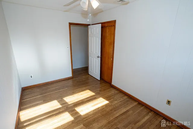 a view of room with window and hardwood floor