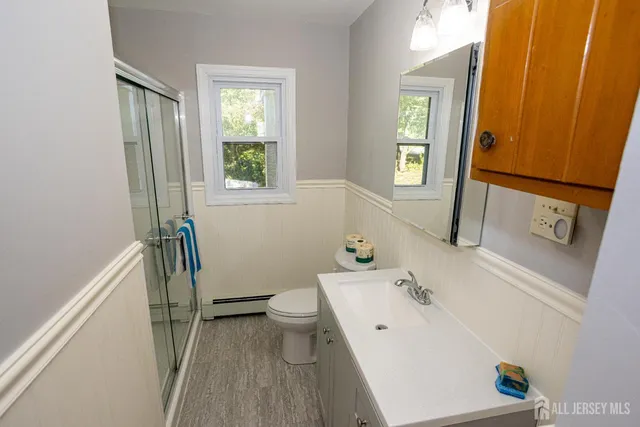 a bathroom with a sink a toilet and a window