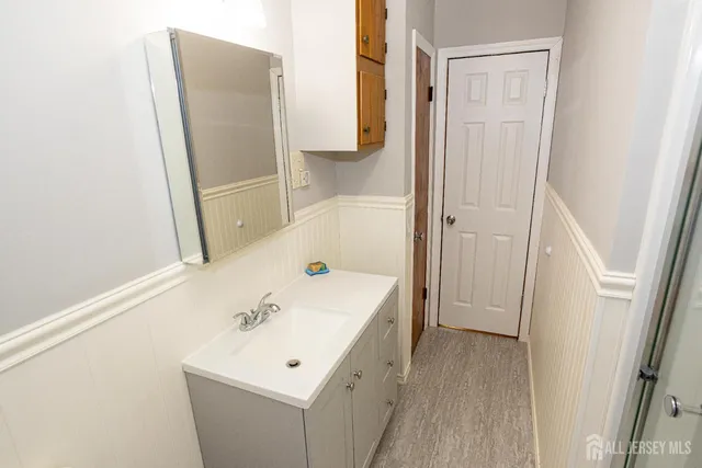 a bathroom with a sink a mirror and a shower