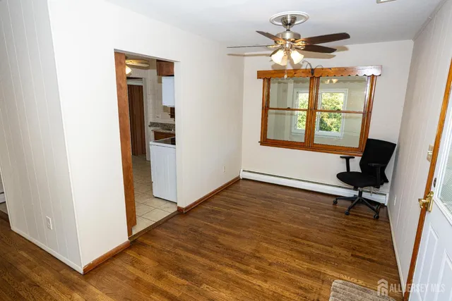 a view of a room with a window and wooden floor