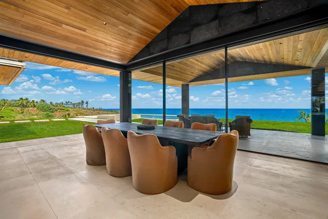 a view of swimming pool with a table and chairs under an umbrella