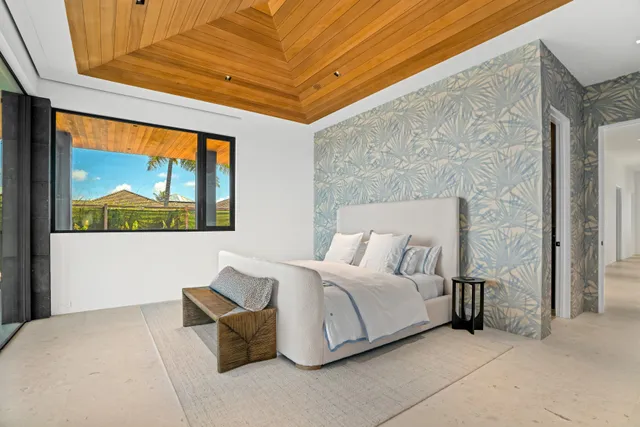 a bedroom with a bed and a painting on the wall