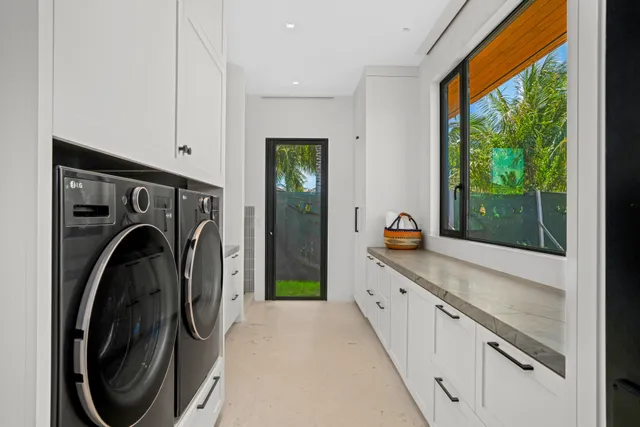 a view of a hallway with washer and dryer