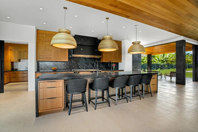 a kitchen with stainless steel appliances granite countertop a sink a stove and a wooden floors