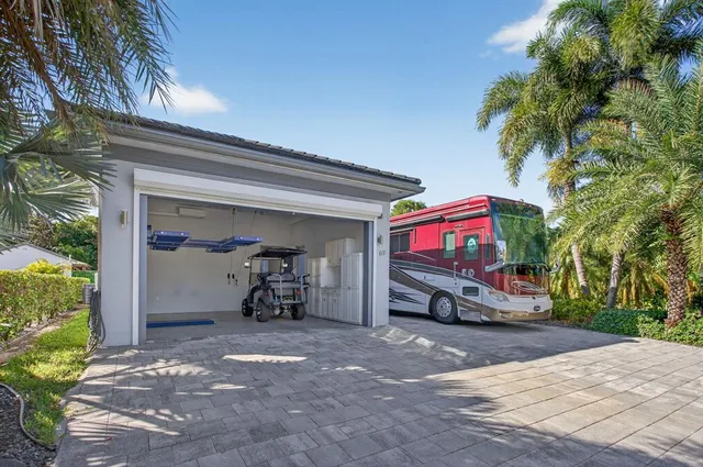 a large white room with a large window and chandelier