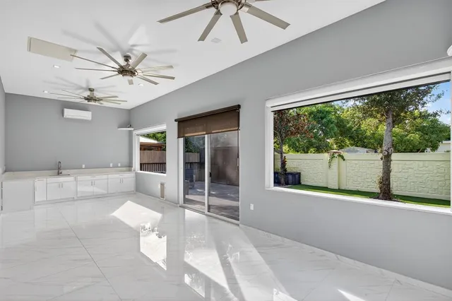 a view of a porch with furniture and a yard