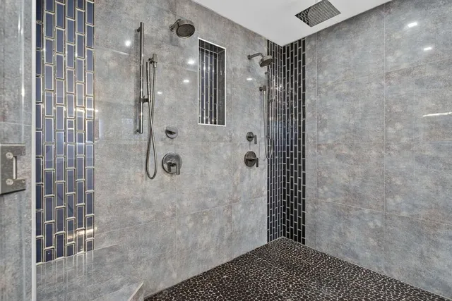 a bathroom with a bathtub sink and mirror