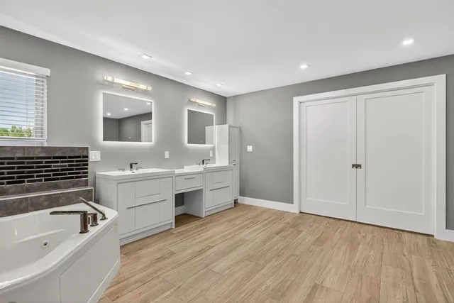 a kitchen with a refrigerator and wooden floor