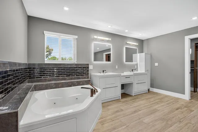 a kitchen with white cabinets and sink
