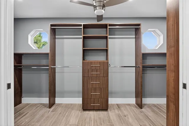 a kitchen with granite countertop white cabinets and a refrigerator