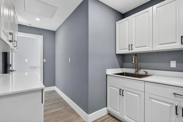 a backyard of a house with barbeque oven and trees