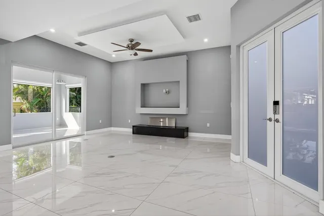 a dining hall with stainless steel appliances kitchen island granite countertop a refrigerator and a sink