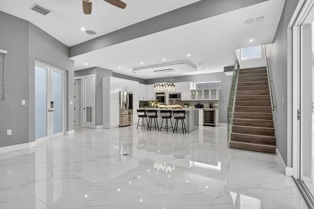 a kitchen with kitchen island granite countertop lots of counter top space and stainless steel appliances