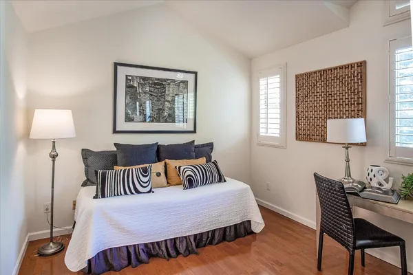 a bedroom with furniture and a lamp