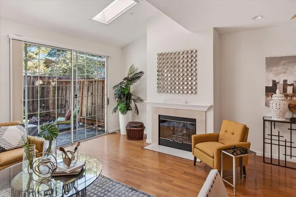 a living room with furniture fireplace and a large window