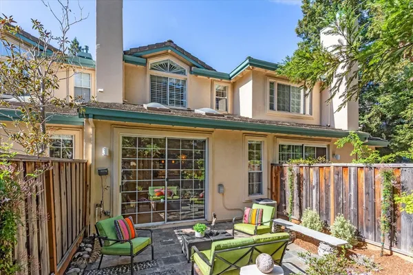 a view of a chair and table in front of a house