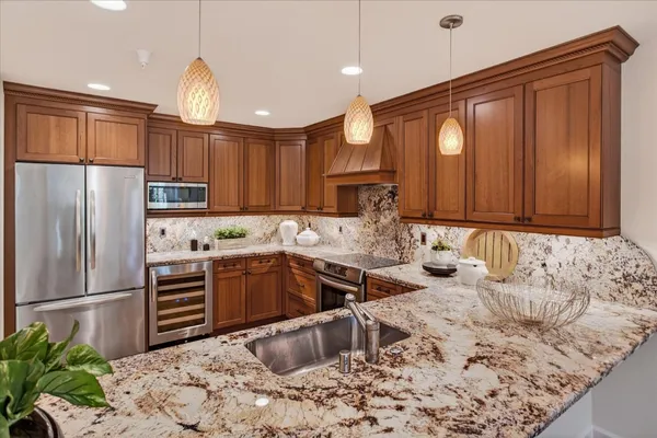 a kitchen with a sink refrigerator and cabinets