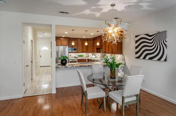 a dining room with furniture and chandelier