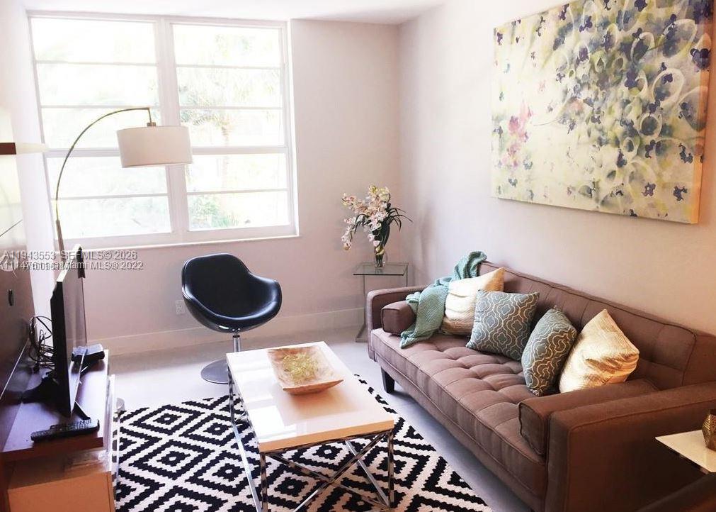 100 Lincoln Road, Unit 426 Miami Beach, FL 33139 - Photo 1 of 8 a living room with furniture and a rug
