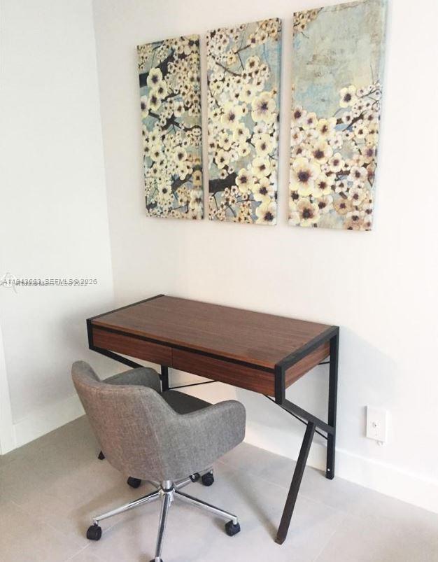 100 Lincoln Road, Unit 426 Miami Beach, FL 33139 - Photo 3 of 8 a blue chair sitting next to a small window