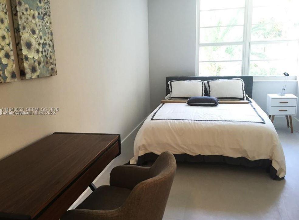 100 Lincoln Road, Unit 426 Miami Beach, FL 33139 - Photo 4 of 8 a bed sitting in a bedroom next to a window