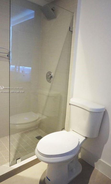 100 Lincoln Road, Unit 426 Miami Beach, FL 33139 - Photo 7 of 8 a white toilet sitting next to a bath tub