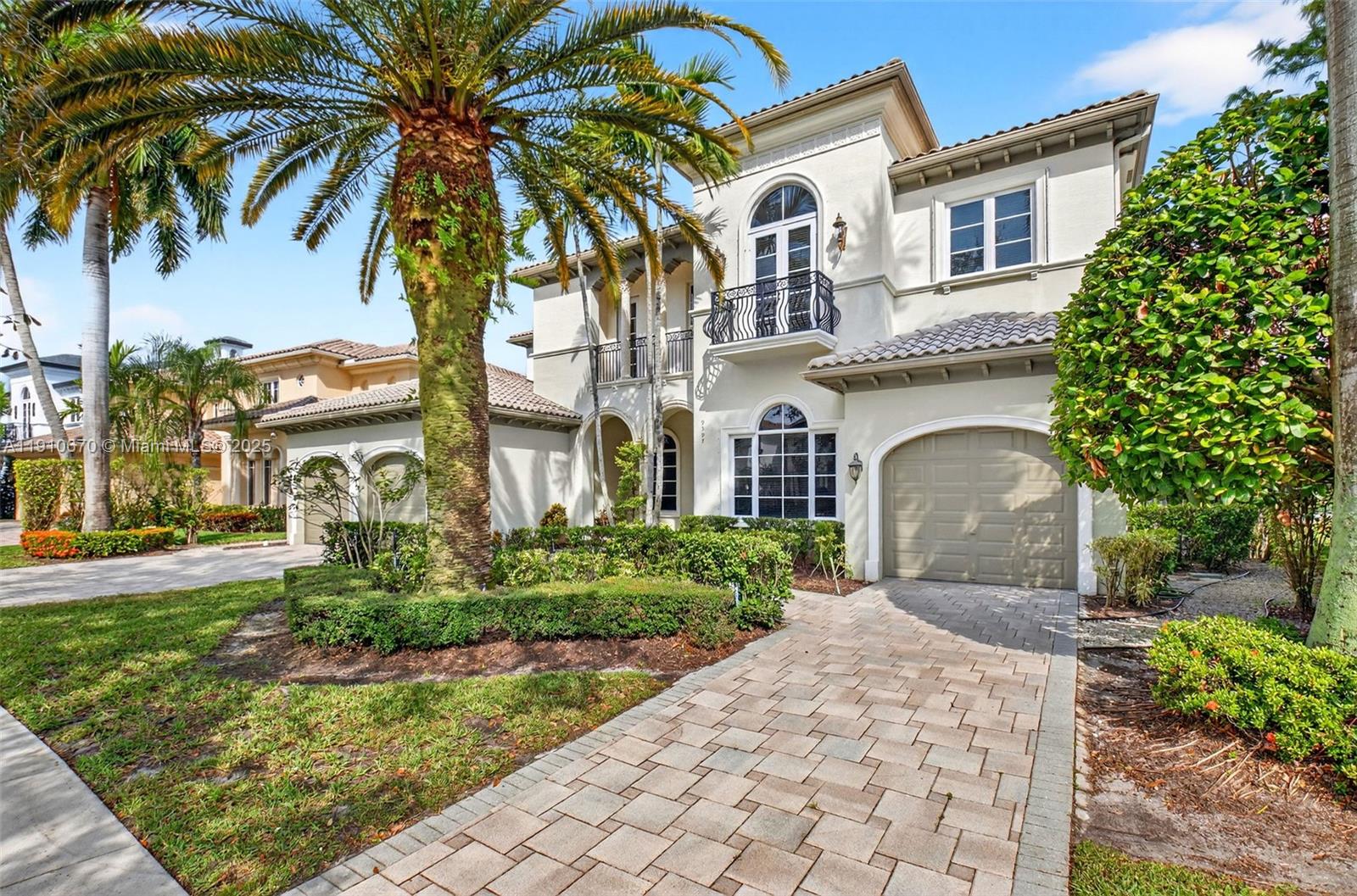 9597 Bridgebrook Drive Boca Raton, FL 33496 - Photo 2 of 88 a front view of a house with a garden