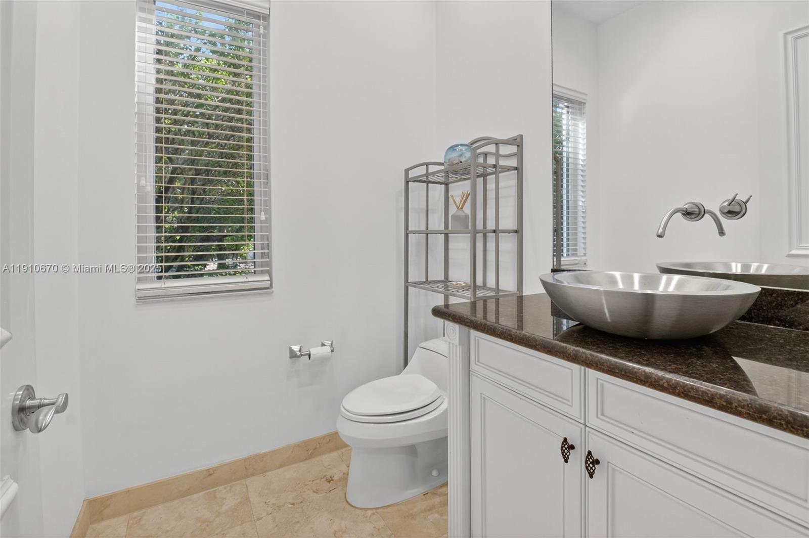 9597 Bridgebrook Drive Boca Raton, FL 33496 - Photo 28 of 88 a spacious bathroom with a toilet a sink and mirror