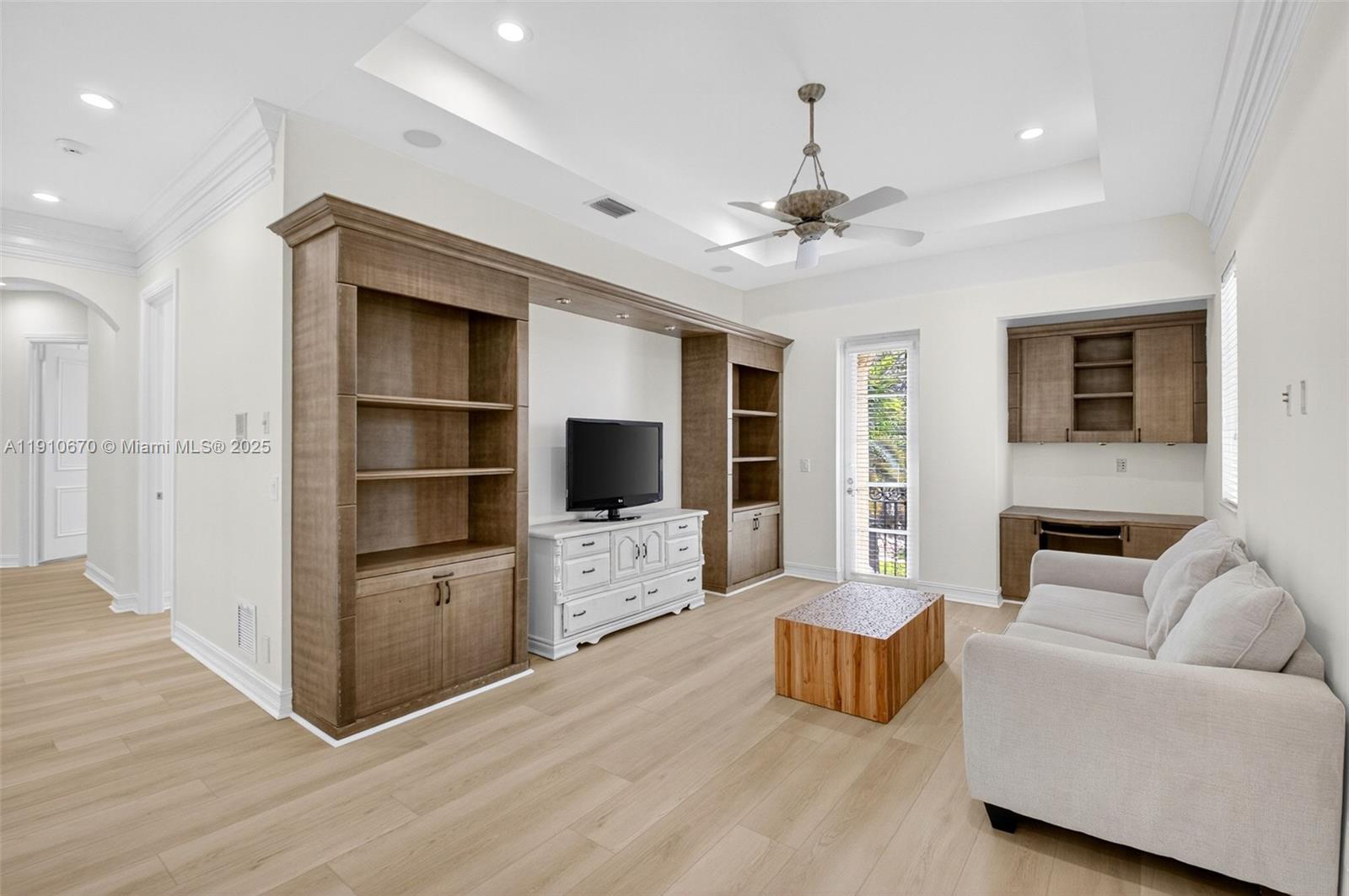 9597 Bridgebrook Drive Boca Raton, FL 33496 - Photo 32 of 88 a living room with furniture and a flat screen tv