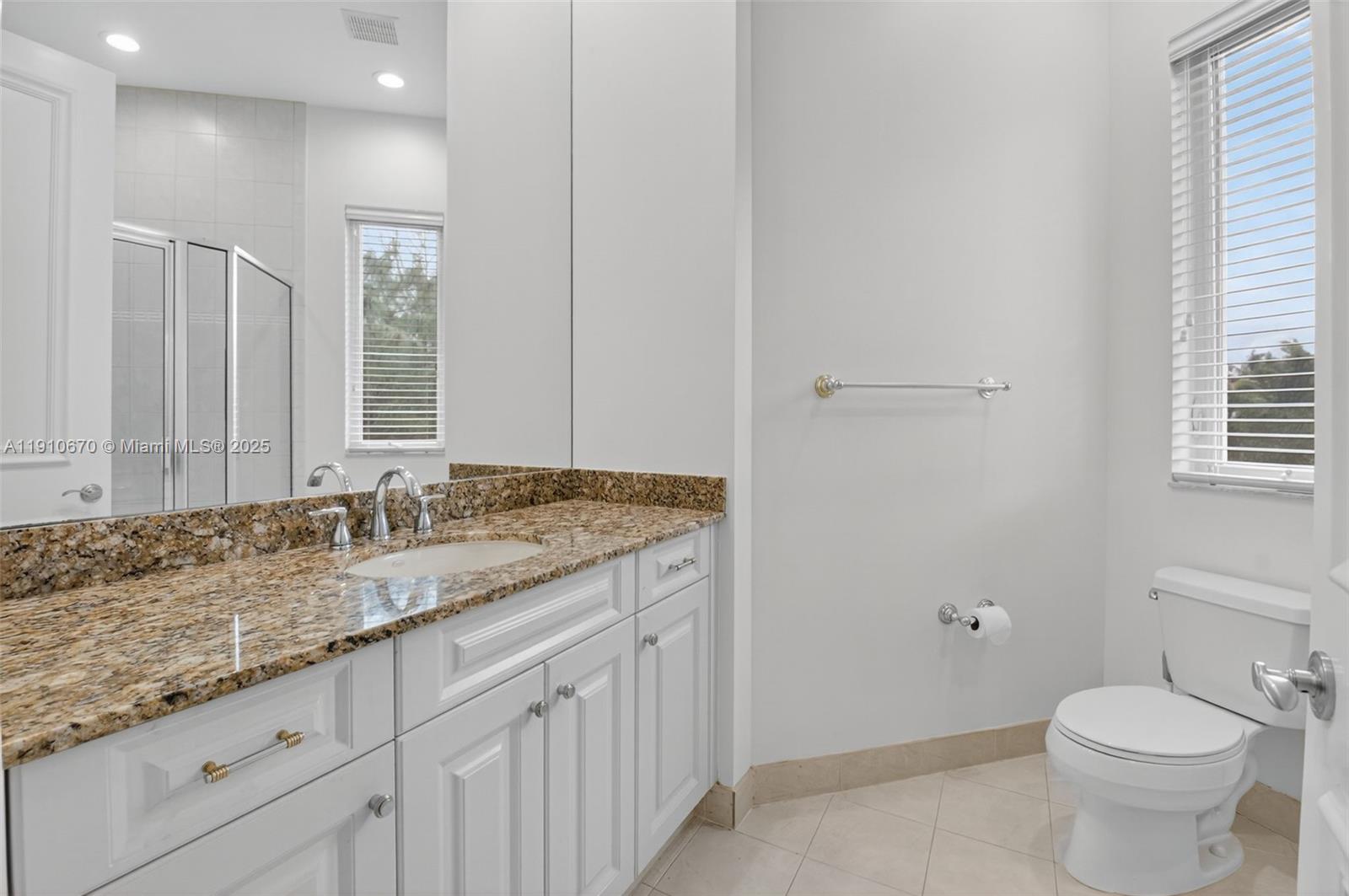 9597 Bridgebrook Drive Boca Raton, FL 33496 - Photo 38 of 88 a bathroom with a granite countertop sink and a toilet
