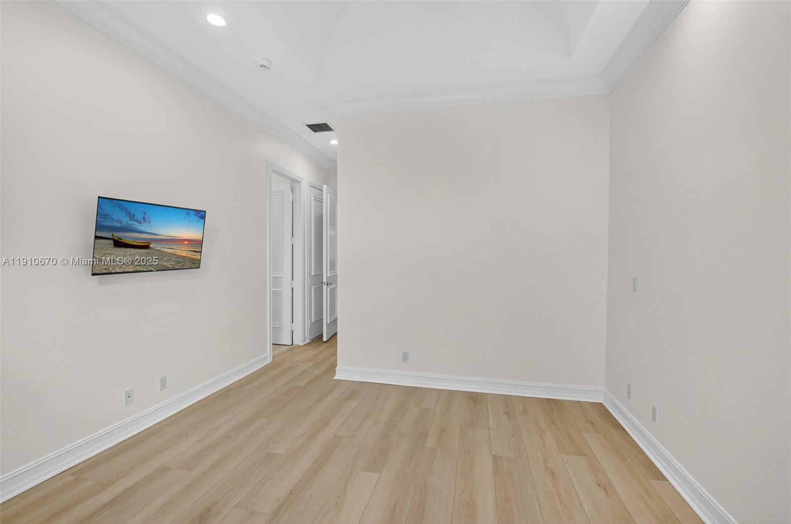 9597 Bridgebrook Drive Boca Raton, FL 33496 - Photo 39 of 88 a view of an empty room with wooden floor and a window