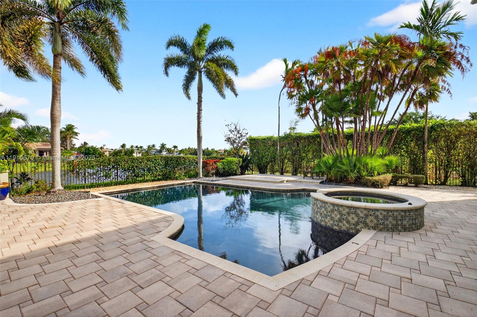 9597 Bridgebrook Drive Boca Raton, FL 33496 - Photo 57 of 88 a view of swimming pool with a table and chairs