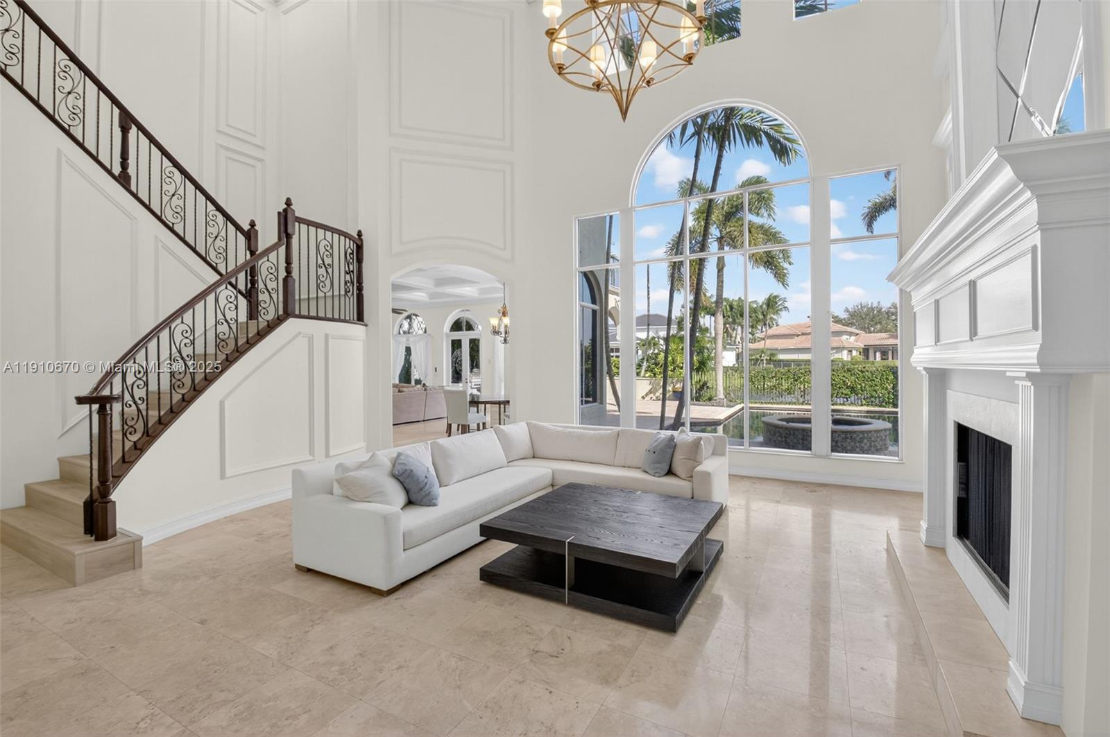 9597 Bridgebrook Drive Boca Raton, FL 33496 - Photo 8 of 88 a living room with fireplace furniture and a floor to ceiling window
