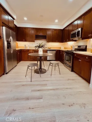 a kitchen with stainless steel appliances kitchen island granite countertop a sink and cabinets