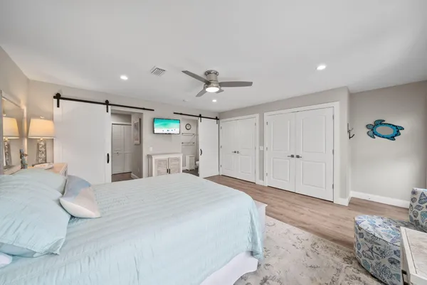a bedroom with a bed and a chandelier