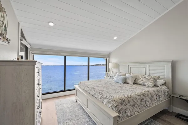 a bedroom with a large bed and a large window