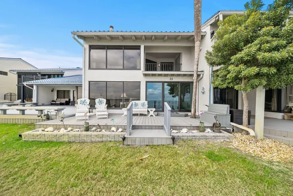 a balcony with wooden floor and glass door