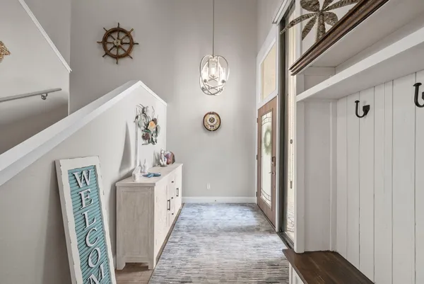 a view of an entryway with wooden floor