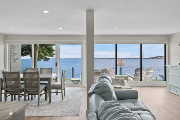 a living room with furniture and large windows