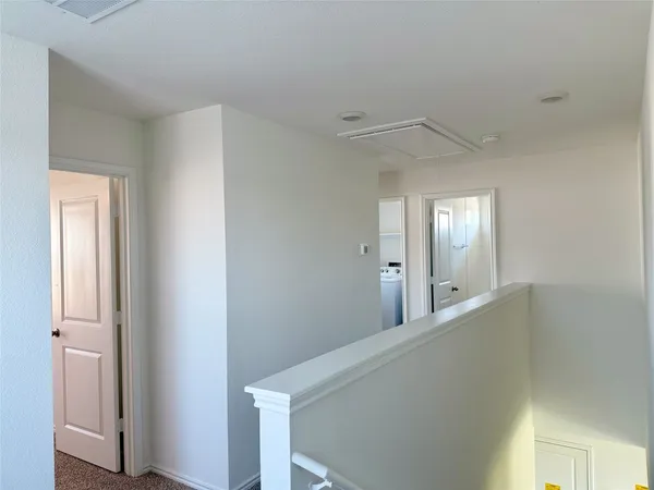 a view of a hallway with windows