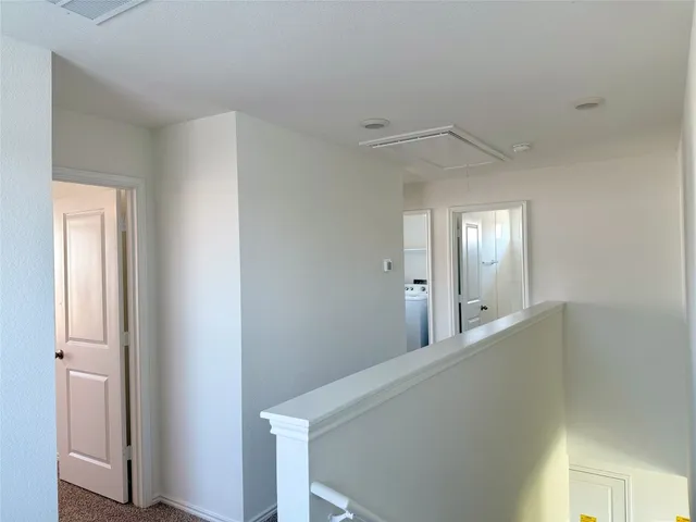 a view of a hallway with windows