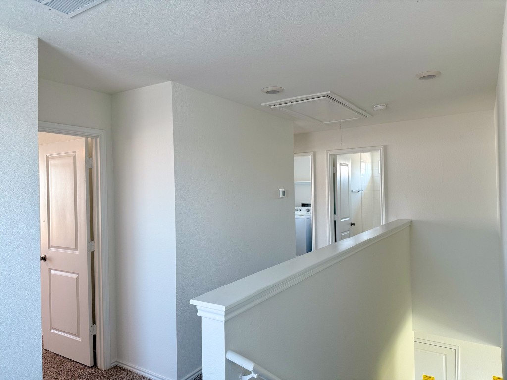 224 Inks Lane Kyle, TX 78640 - Photo 11 of 13 a view of a hallway with windows